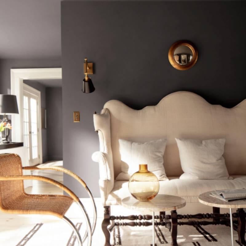 Benjamin Moore 2026 Color of the Year Silhouette AF-655 on a moody charcoal bedroom wall with warm neutral furniture and brass accents