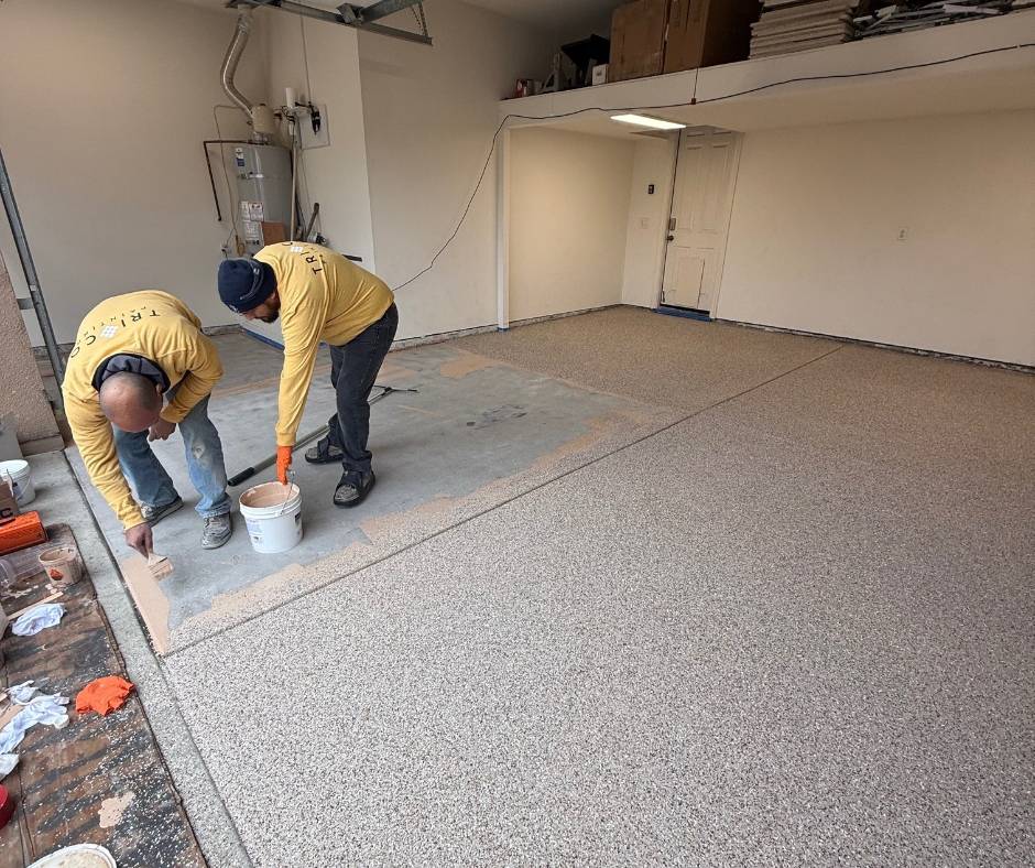 TRICO PAINTING applying the final section of an epoxy moisture-mitigating base coat on a garage floor before full flake broadcast and polyaspartic top coat installation in Roseville, California.