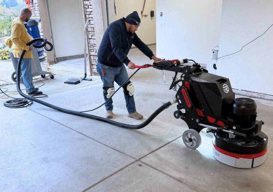 TRICO PAINTING performing professional diamond grinding to prepare a concrete garage floor for an epoxy moisture barrier and polyaspartic coating system in Roseville, California.