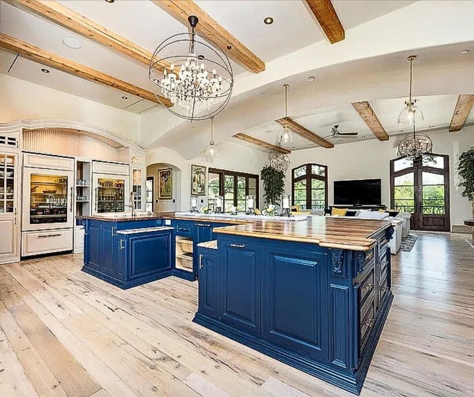Luxury interior painting project in Catta Verdera, Lincoln CA featuring custom deep blue kitchen cabinetry, wood countertops, exposed ceiling beams, and a high-end open-concept design.
