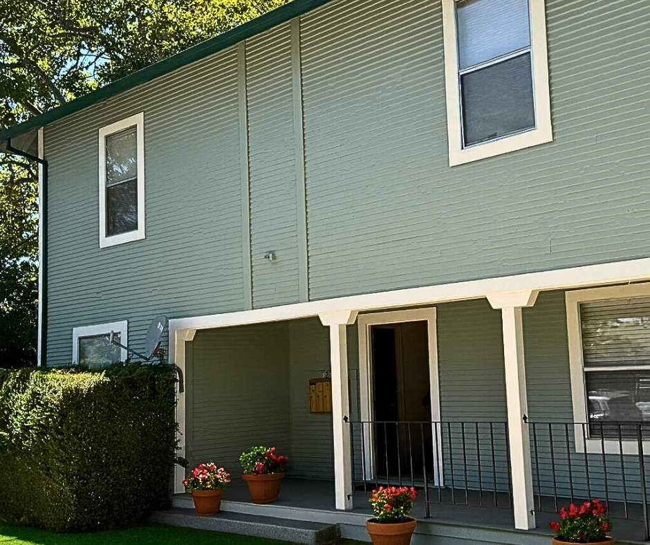 Modern green exterior house painted by Trico Painting with white trim (2026 exterior color trend)