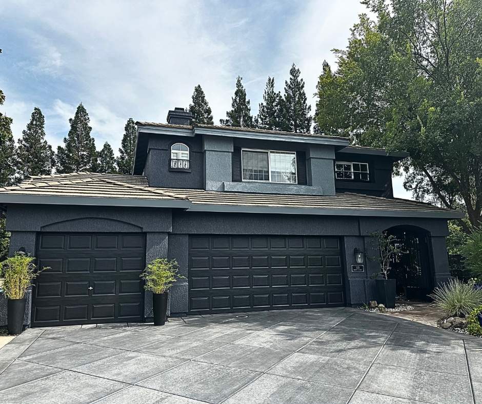 Two-story dark charcoal exterior house painted by Trico Painting (2026 exterior color trend)